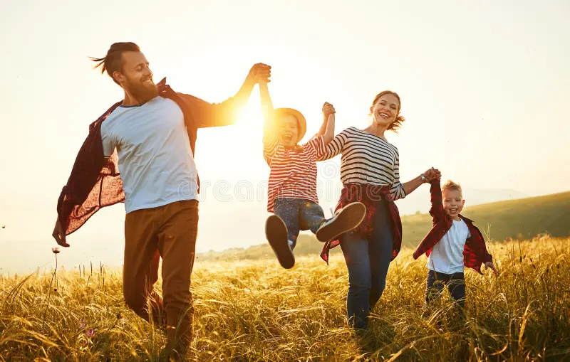 A family enjoying time together in a golden field at sunset